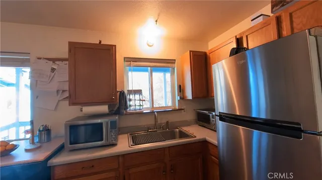 a kitchen with stainless steel appliances granite countertop a stove and a refrigerator