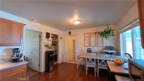 a dining room with furniture and wooden floor