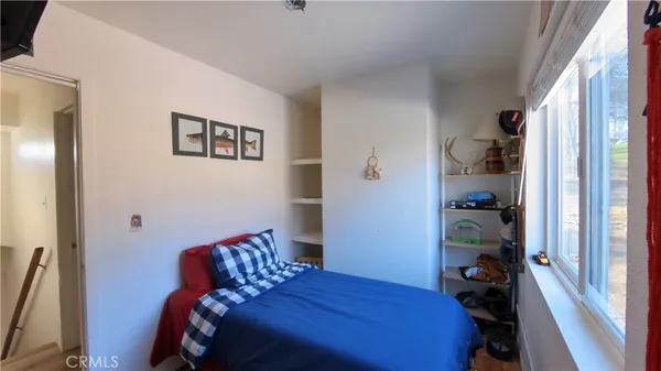 a bedroom with a bed and a window