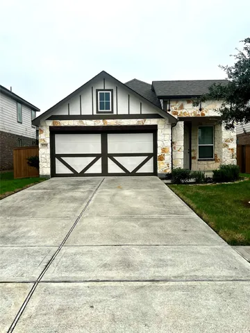 a view of a house with a yard and potted plants