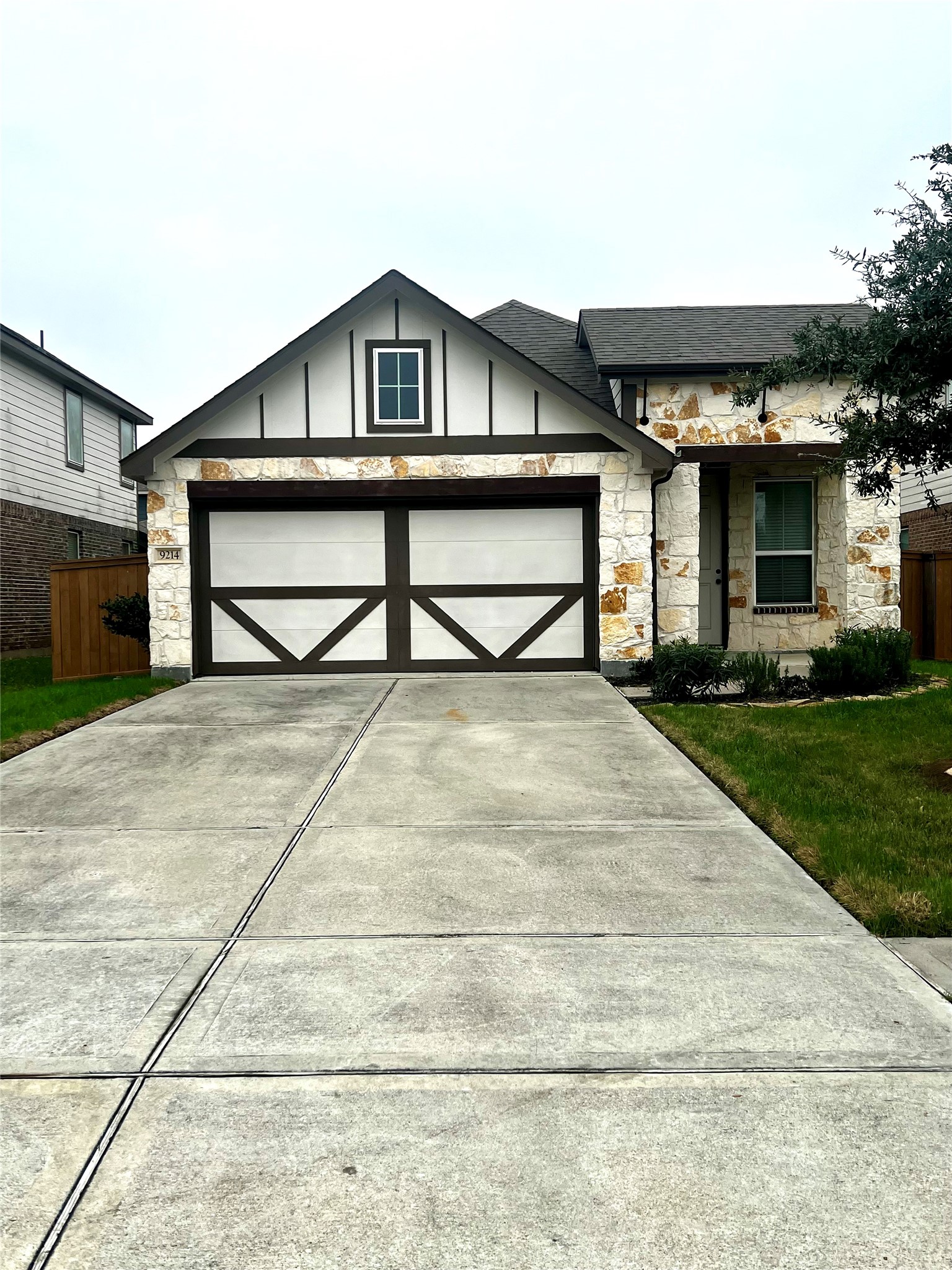a view of a house with a yard and potted plants