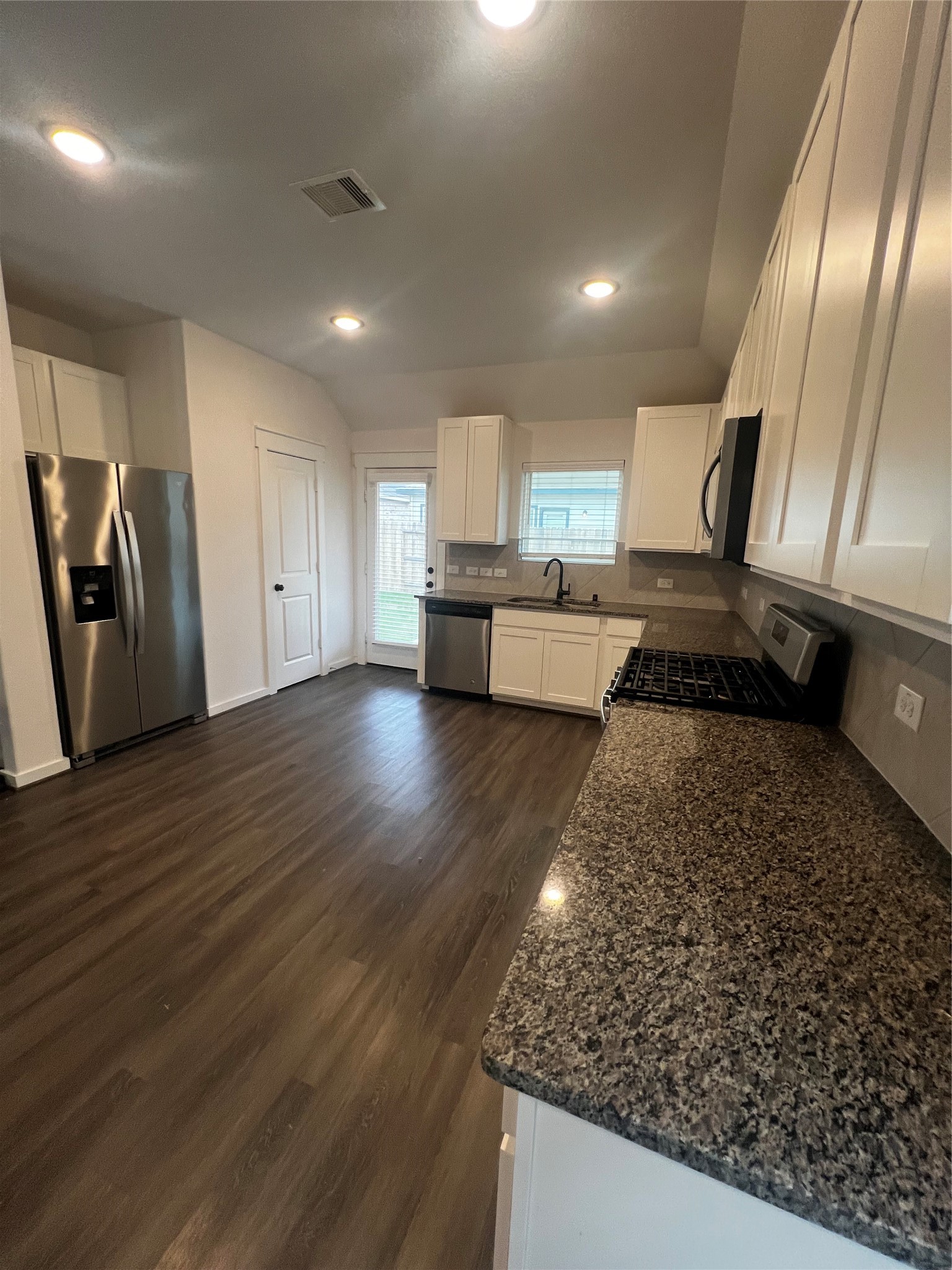 9214 Melmack Drive Rosharon, TX 77583 - Photo 2 of 14 a living room with stainless steel appliances granite countertop furniture wooden floor and a view of kitchen