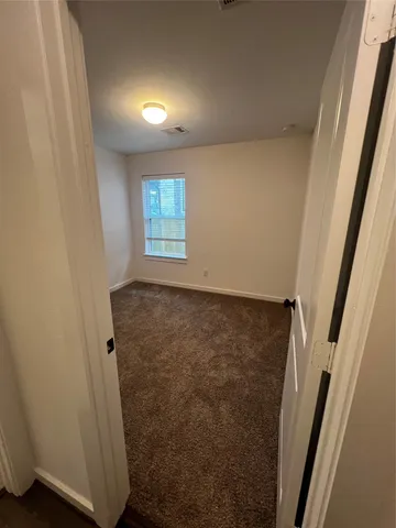 a view of an empty room with a window