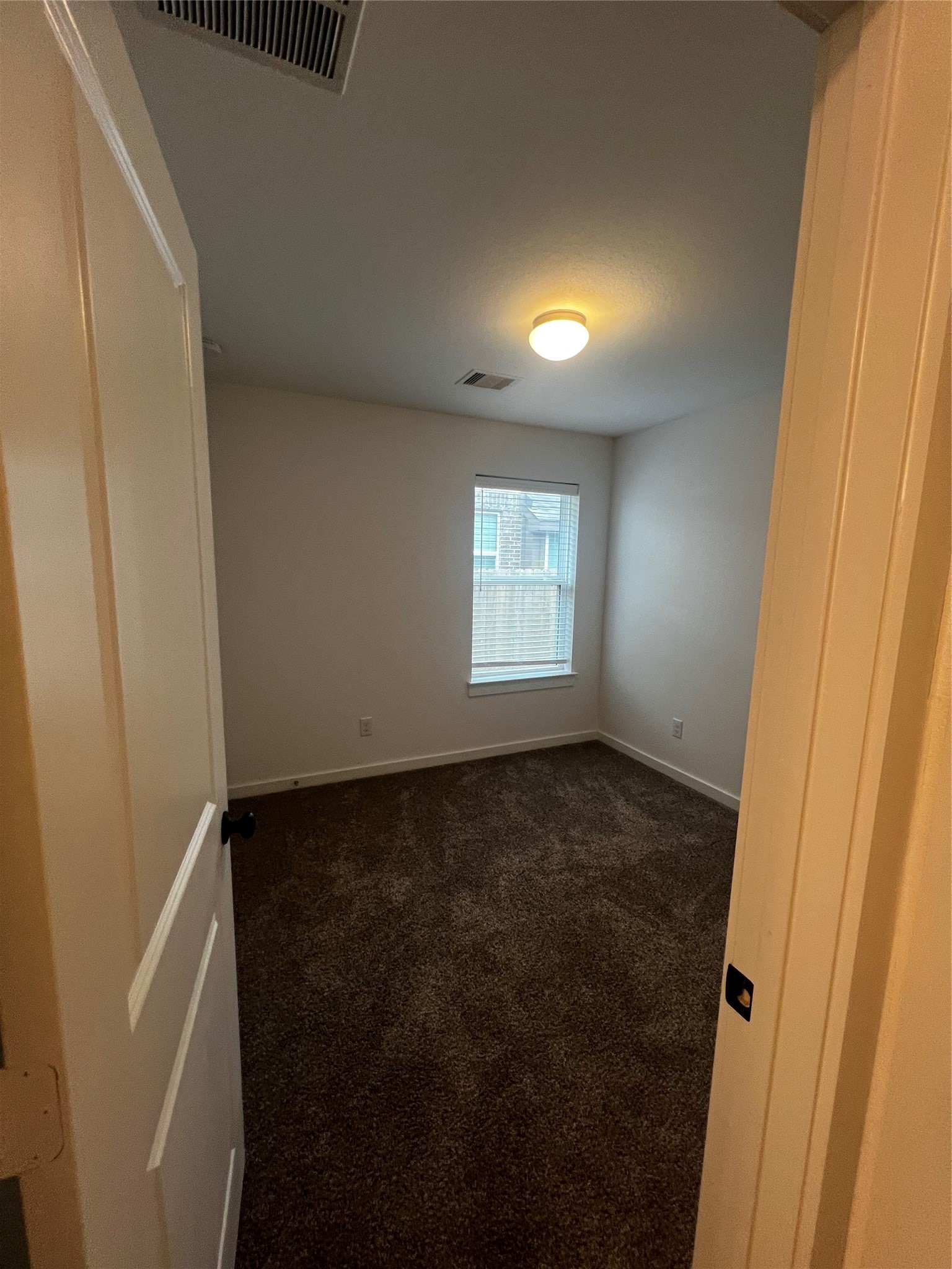 9214 Melmack Drive Rosharon, TX 77583 - Photo 8 of 14 a view of an empty room with a window