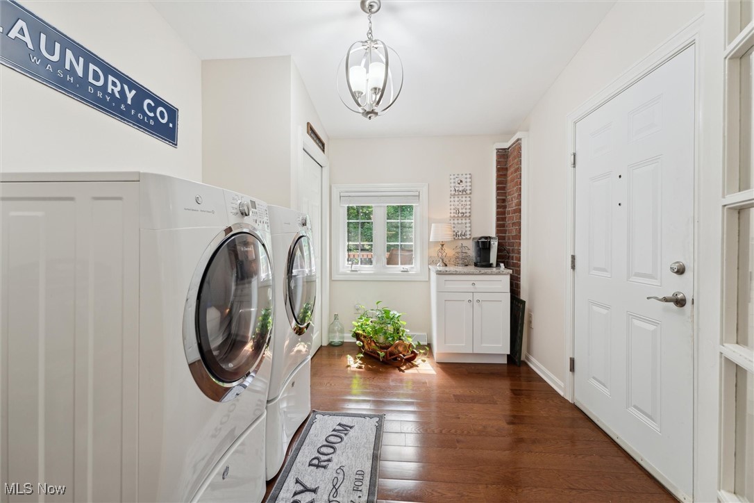 1059 Gulf Road Elyria, OH 44035 - Photo 47 of 50 Laundry room featuring washer and clothes dryer, cabinets, a notable chandelier, and dark hardwood / wood-style floors