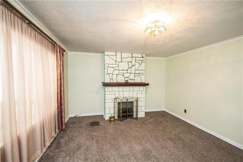222 Ann Street McKees Rocks, PA 15136 - Photo 2 of 24 The living room has crown molding, newer carpet, decorative fireplace & large window to let in tons of natural light.