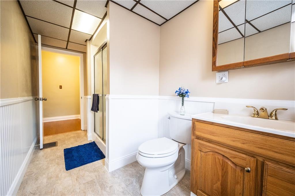 222 Ann Street McKees Rocks, PA 15136 - Photo 7 of 24 The remodeled main bathroom has soft close cabinetry, wains coating, step in shower with a seat & new commode.