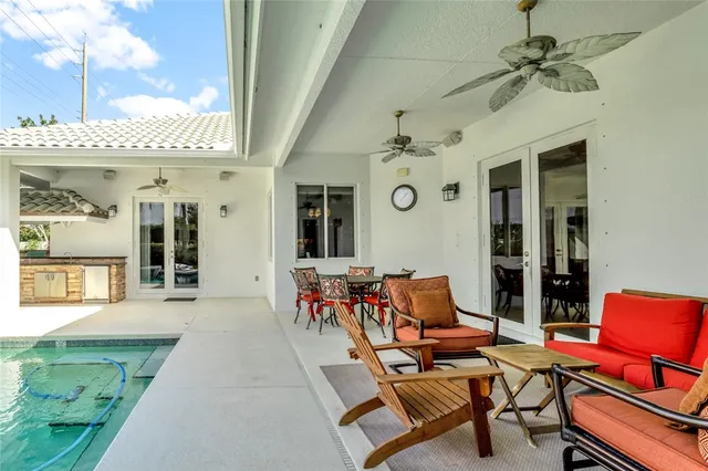 a outdoor space with patio the couches and a potted plant with table and chairs