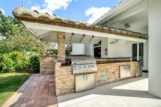a kitchen with stainless steel appliances granite countertop a stove and a wooden floors