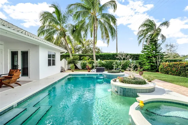 a swimming pool with barbeque oven outdoor seating yard and fire pit