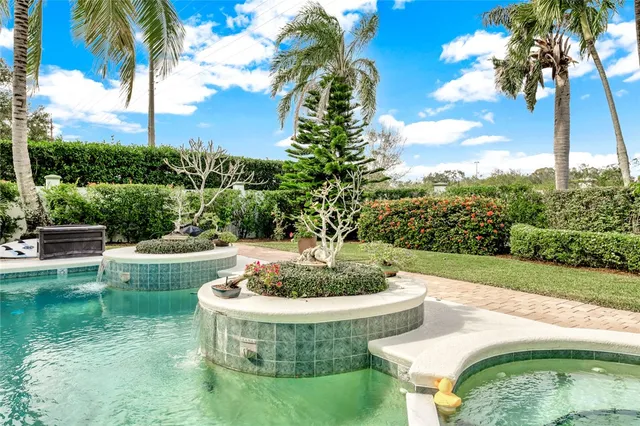 a view of a swimming pool with a table and chairs