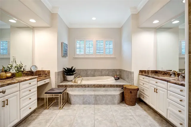 a spacious bathroom with a granite countertop tub sink and mirror