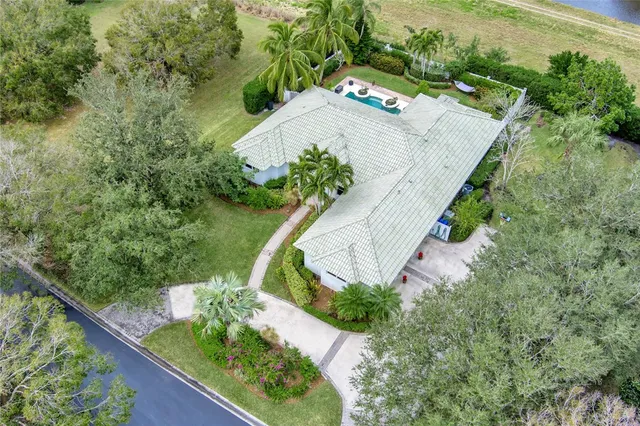 an aerial view of a house with a yard