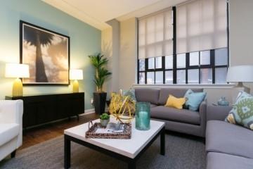 908 Penn Avenue Pittsburgh, PA 15222 - Photo 2 of 9 a living room with furniture lamp and window