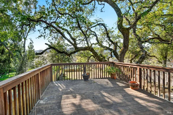 a view of balcony with wooden floor and fence