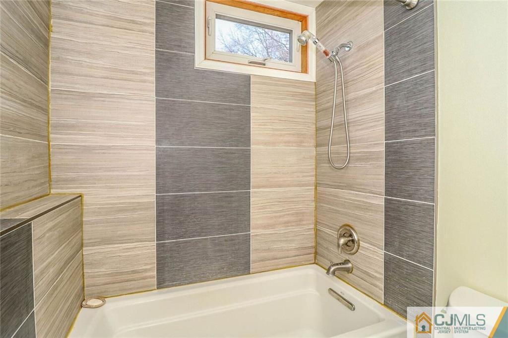 24 Ridge Road Edison, NJ 08817 - Photo 14 of 25 a bathroom with a bathtub and shower