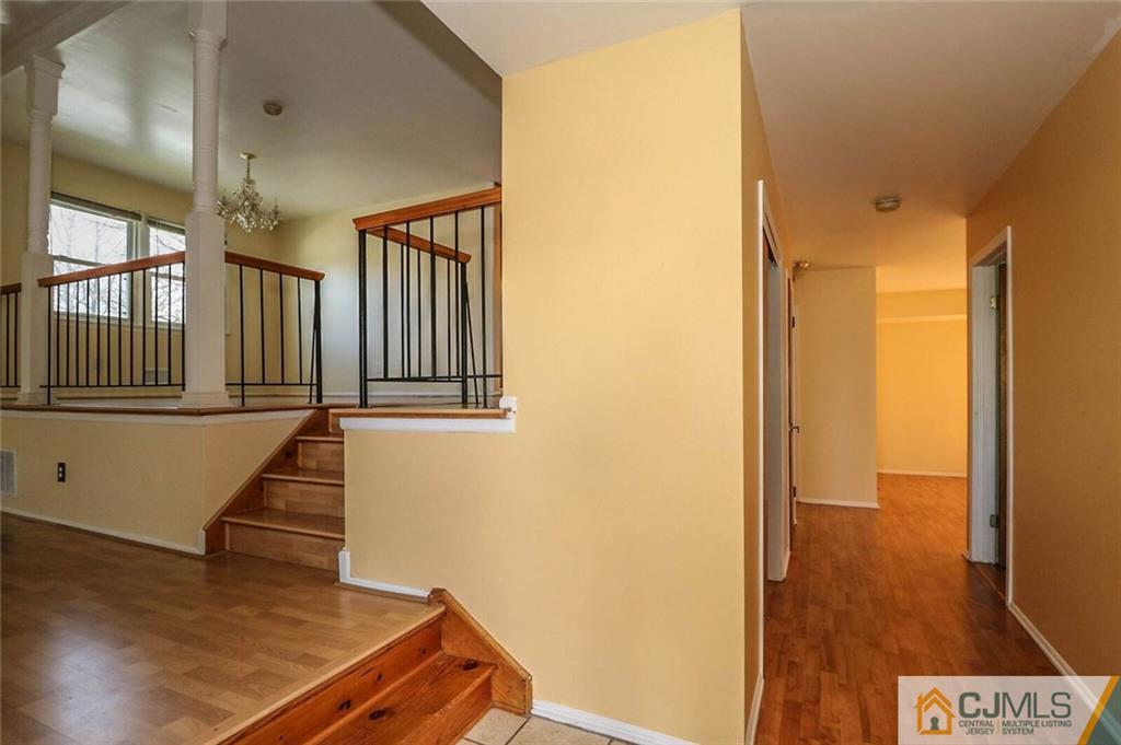 24 Ridge Road Edison, NJ 08817 - Photo 7 of 25 a view of a hallway with wooden floor and staircase