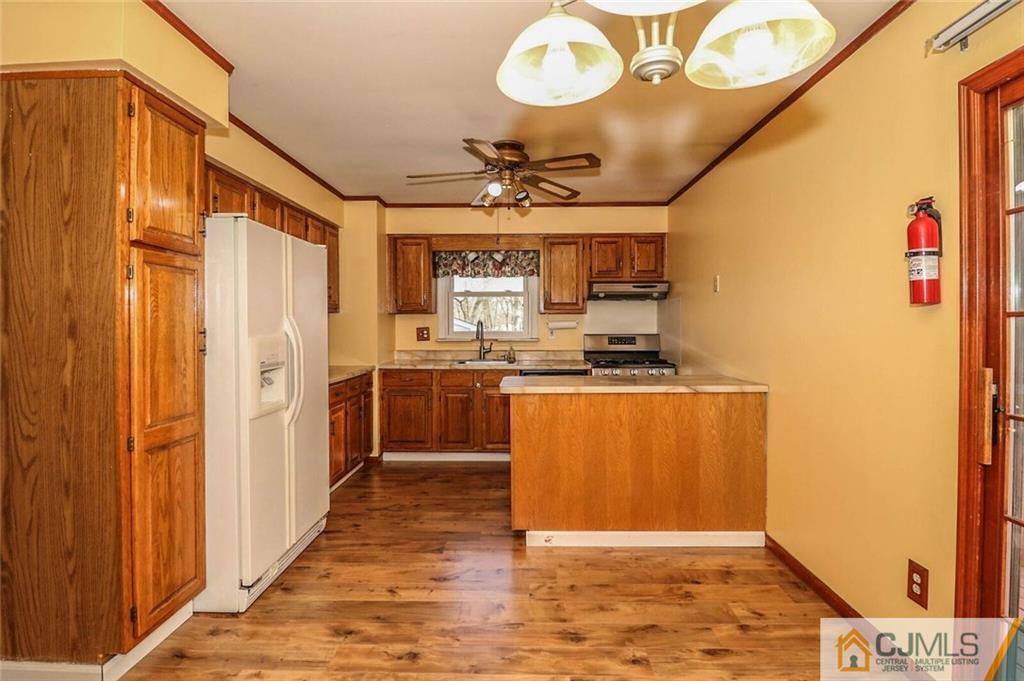 24 Ridge Road Edison, NJ 08817 - Photo 9 of 25 a view of kitchen with stainless steel appliances granite countertop a stove a sink and a refrigerator with wooden floor