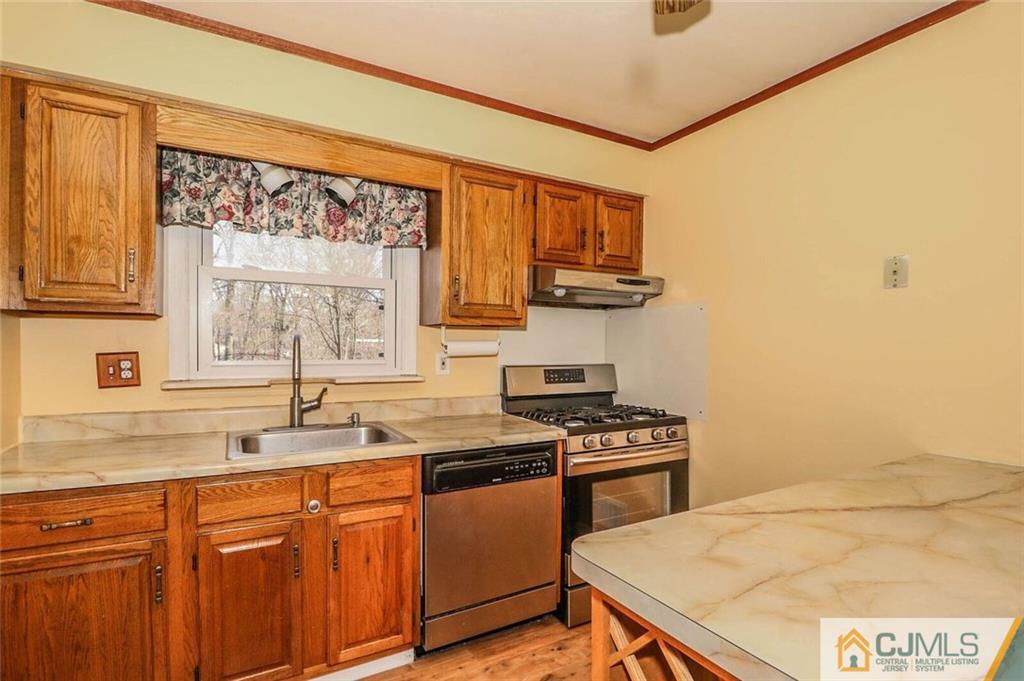 24 Ridge Road Edison, NJ 08817 - Photo 10 of 25 a kitchen with stainless steel appliances a sink stove and a window