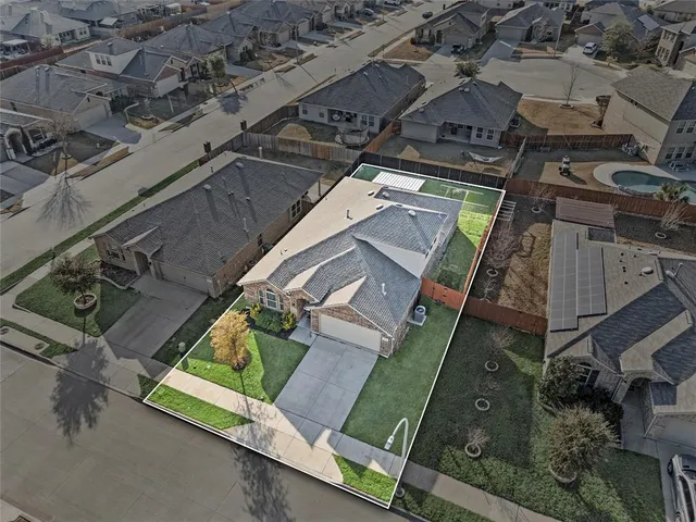 a house with green field in front of it