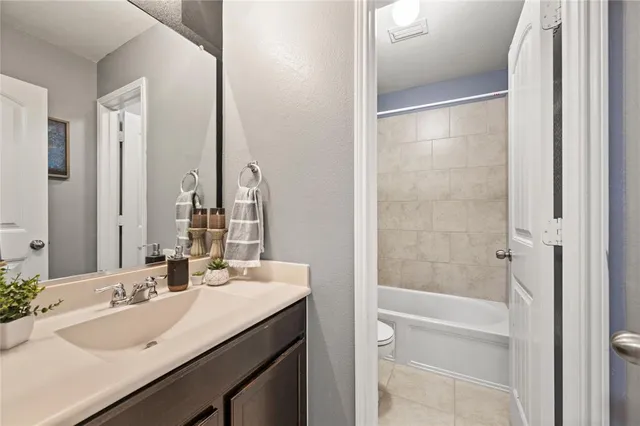 a view of a backyard with table and chairs under an umbrella with a small yard