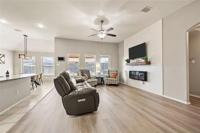 a kitchen with stainless steel appliances granite countertop a sink stove microwave and refrigerator