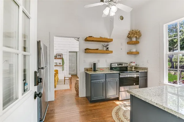 a kitchen with a refrigerator and a stove