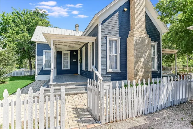 a front view of house with a garden