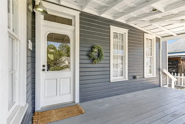 a view of a porch with wooden floor and a fireplace