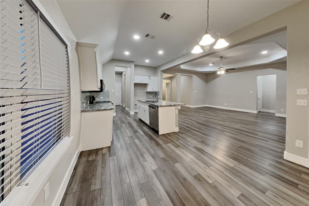 237 Giddings Trail Forney, TX 75126 - Photo 4 of 18 a kitchen with stainless steel appliances a refrigerator and wooden floor