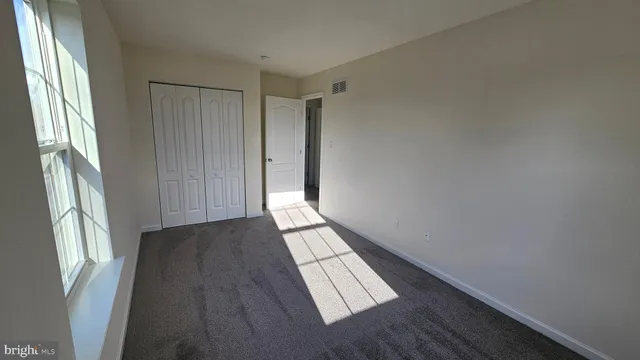 a view of wooden floor and windows in a room