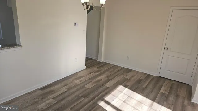 a view of hallway with wooden floor
