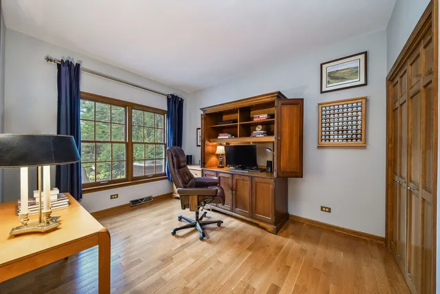 a view of a workspace with furniture and a window