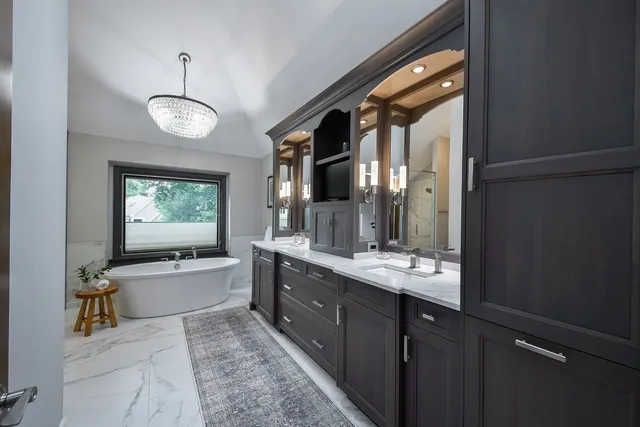a large bathroom with a large tub and sink