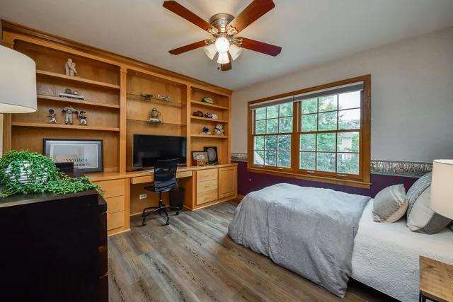 a bedroom with a bed and a television