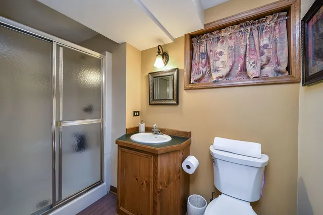a bathroom with a toilet sink and mirror