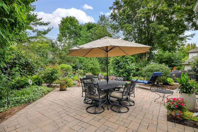 a view of backyard with plants and outdoor seating