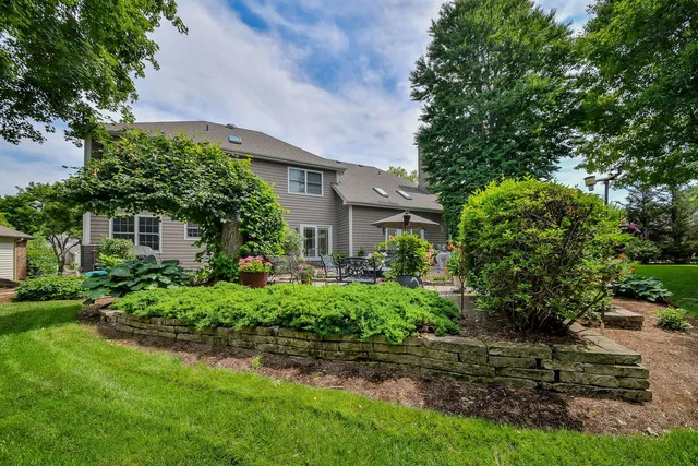 a front view of a house with a yard and trees