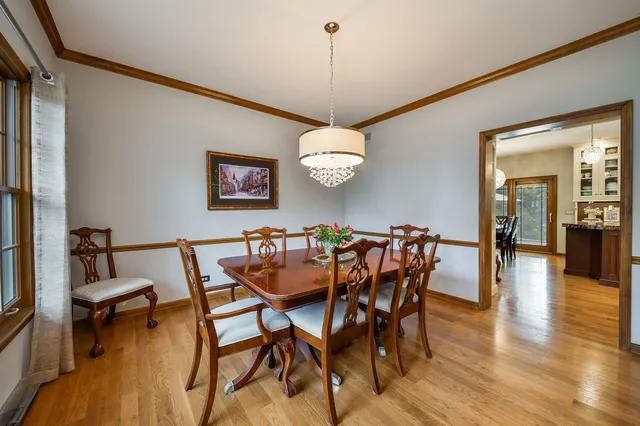 a dining room with furniture and wooden floor