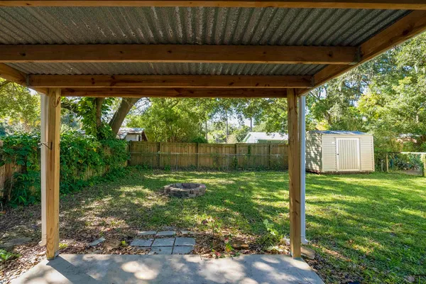 a backyard of a house with a garden and outdoor seating