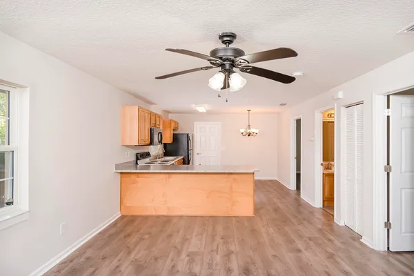 a view of a kitchen with a sink and wooden floor