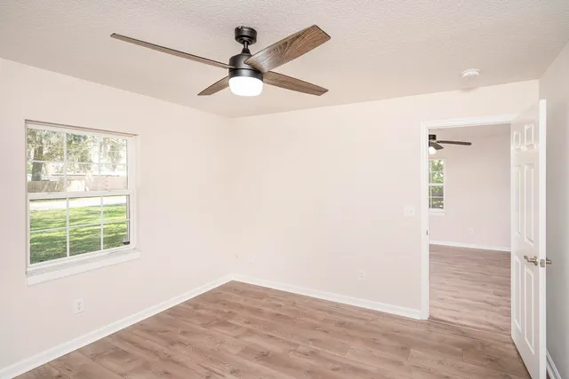 wooden floor in an empty room with a window