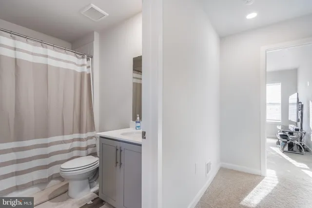a bathroom with a toilet a sink and a shower