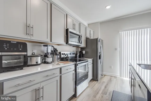 a kitchen with stainless steel appliances granite countertop a refrigerator sink and cabinets