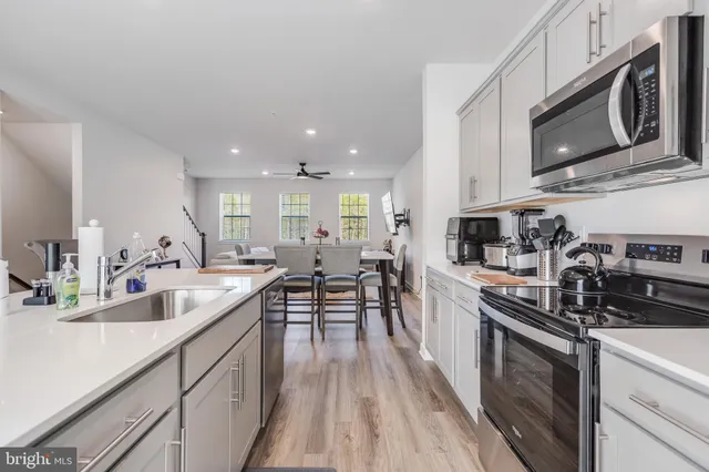 a large kitchen with stainless steel appliances granite countertop a lot of counter space