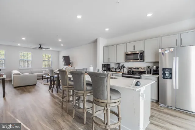 a kitchen with a table chairs refrigerator and microwave