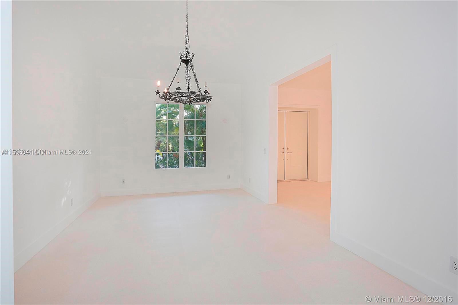 390 Gulf Road Key Biscayne, FL 33149 - Photo 12 of 25 a big room with windows and chandelier