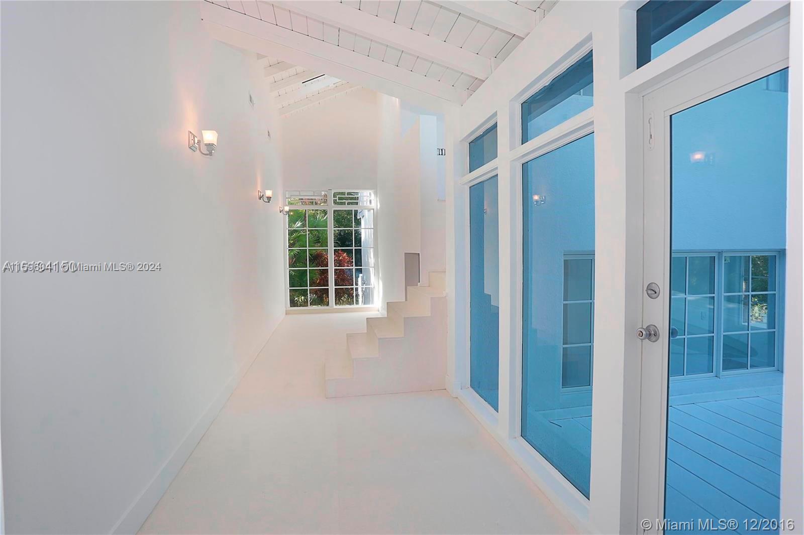 390 Gulf Road Key Biscayne, FL 33149 - Photo 16 of 25 a view of an empty room with wooden floor and a window