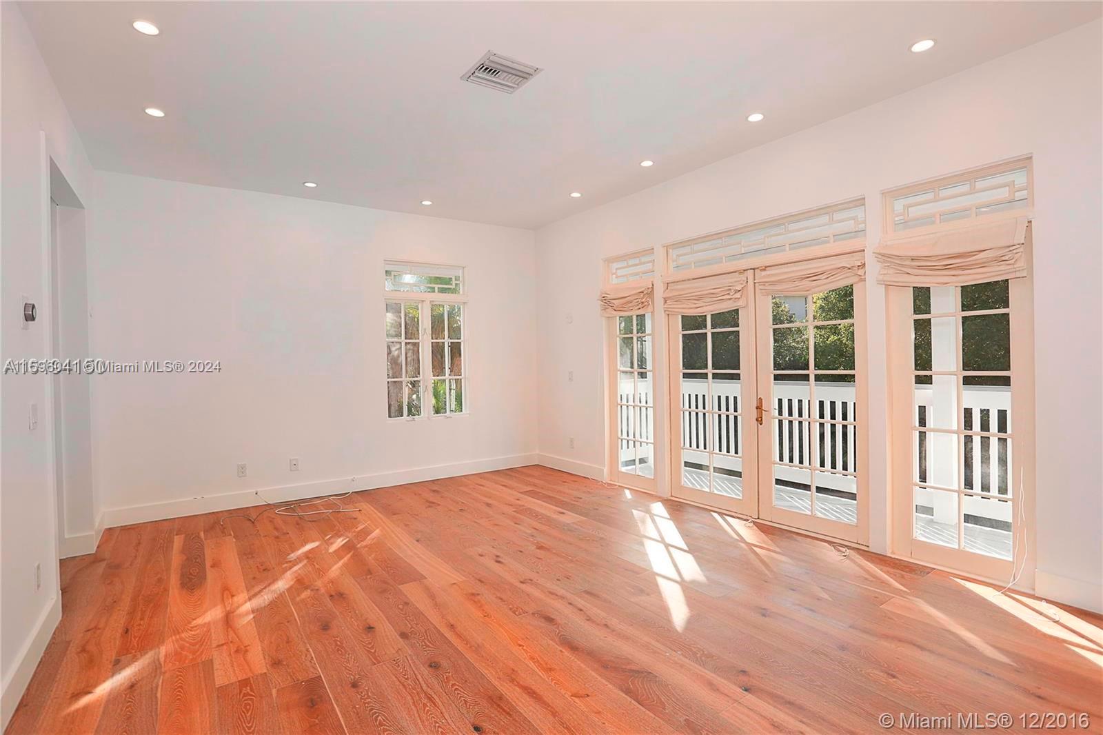 390 Gulf Road Key Biscayne, FL 33149 - Photo 18 of 25 a view of a big room with wooden floor and windows