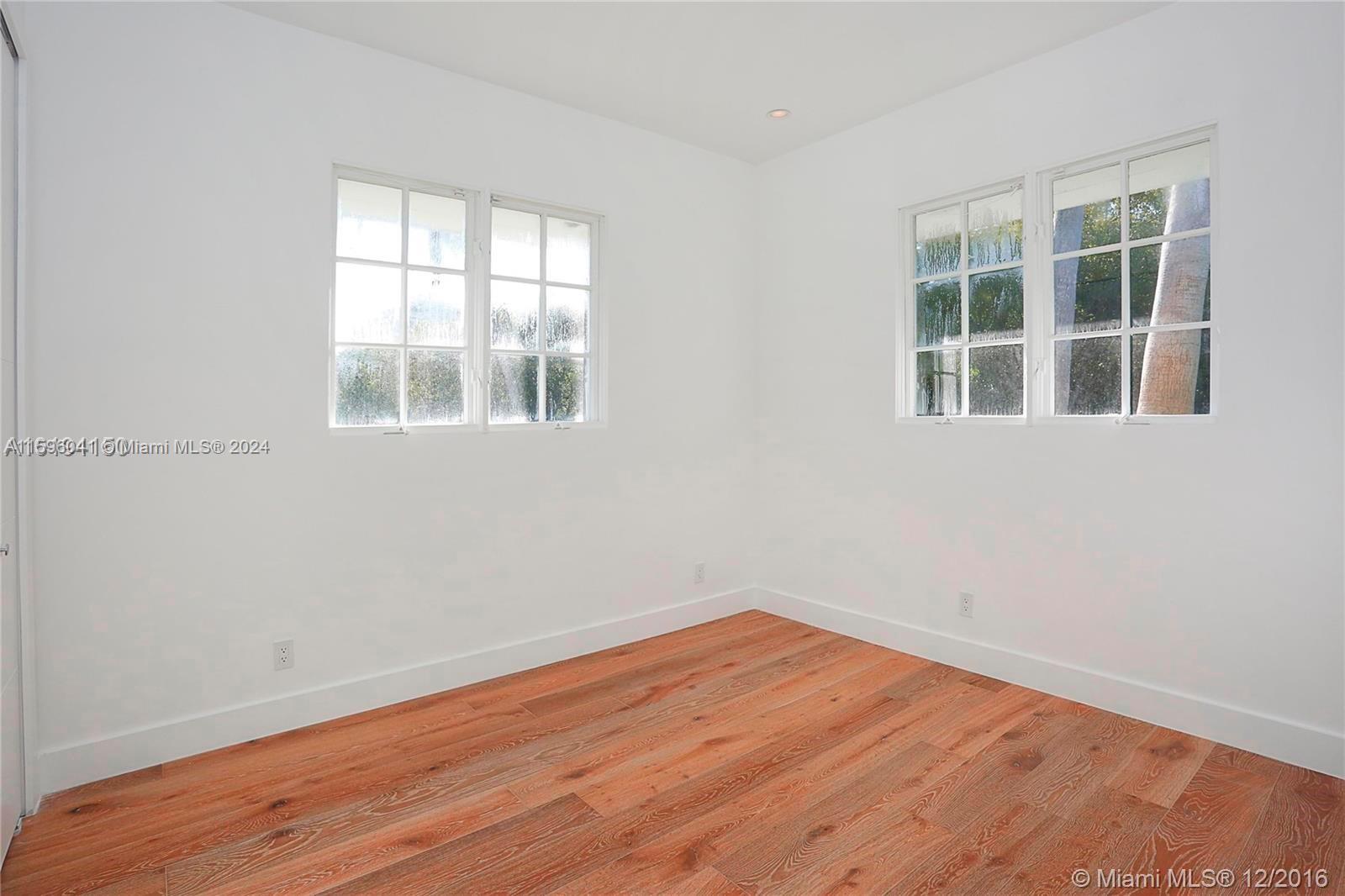 390 Gulf Road Key Biscayne, FL 33149 - Photo 24 of 25 a view of empty room with wooden floor and fan